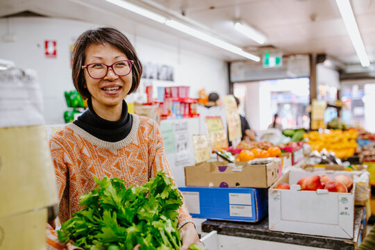 Smiling woman with glasses working in supermarket