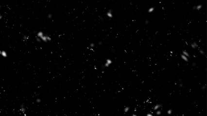 Falling snow flakes, Flying dust particles on a black background. Abstract winter background.