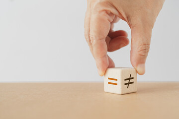 Hand flipping wooden unequal  to equal wooden cube blocks including copy space. For rights , gender...