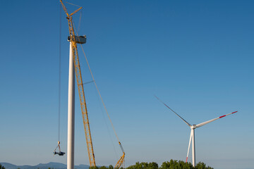Fototapeta premium Construction site on windmill farm during the day from a distance