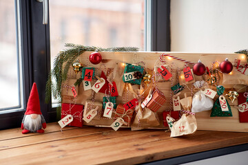 winter holidays and hobby concept - close up of christmas advent calendar with many little gifts...