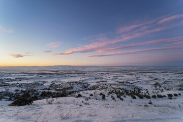 Spectacular snowy landscape from the top of a mountain at sunset.