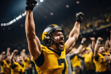 American football player in a yellow uniform rejoices at an abandoned ball in a stadium filled with...
