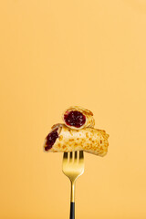 French Crepes with berry jam on fork food concept