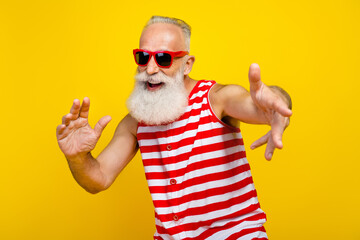 Photo of funky cool elderly guy dressed striped red swimsuit dancing enjoying discotheque isolated...