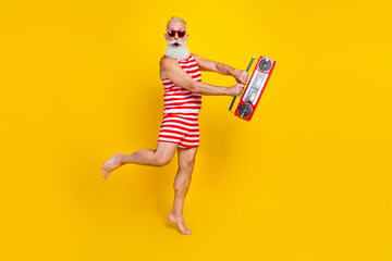 Full length photo of aged man gray bearded hurry up last chance buy tickets for summer ibiza nightclub isolated on yellow color background