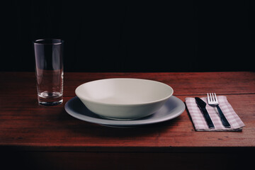 placed at the table with an empty plate, concept of poverty and economic crisis - 667670591
