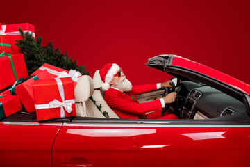 Photo of trendy look driver santa grandpa steering wheel deliver gifts wear costume isolated white...
