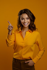 Woman giving finger up with smile on her face on orange background.