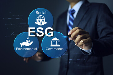 Businessman writing a pen on ESG environmental social governance icon to applied standards and environment action to regulation requirement for complied with business activity - obrazy, fototapety, plakaty