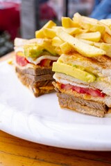 a close up of a sandwich on a plate with chips