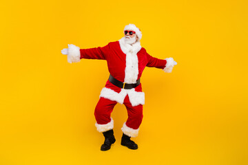 Fototapeta na wymiar Full size photo of carefree charismatic aged santa dancing new year eve isolated on yellow color background