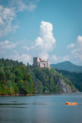 Old castle on the bank of the mountain by the lake