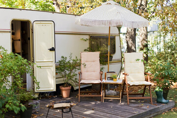 Fototapeta na wymiar Vintage old travel trailer in garden