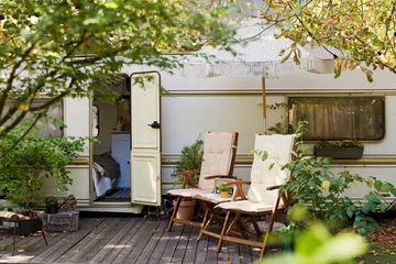 Vintage old travel trailer in garden © aprilante