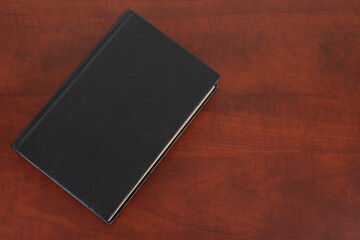 Book on wooden table copy space for text. Education concept.