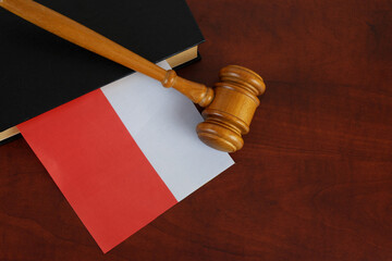 Judge gavel and legal book with flag of Poland on wooden table. Copy space for text.