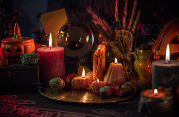 Halloween party, close up magical details including pumpkin and many candles, Home design 