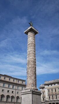 Vertical shot of ancient Egyptian obelisk - Obelisco Agonale on Piazza Navona in Rome on sunny day on background of blue sky. Fountain of Four Rivers - Fontana dei Quattro Fiumi, nobody.