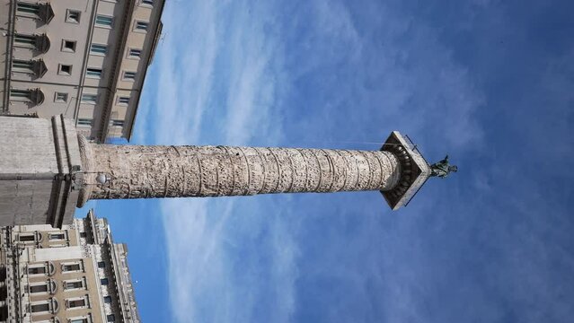 Vertical shot of ancient Egyptian obelisk - Obelisco Agonale on Piazza Navona in Rome on sunny day on background of blue sky. Fountain of Four Rivers - Fontana dei Quattro Fiumi, nobody.