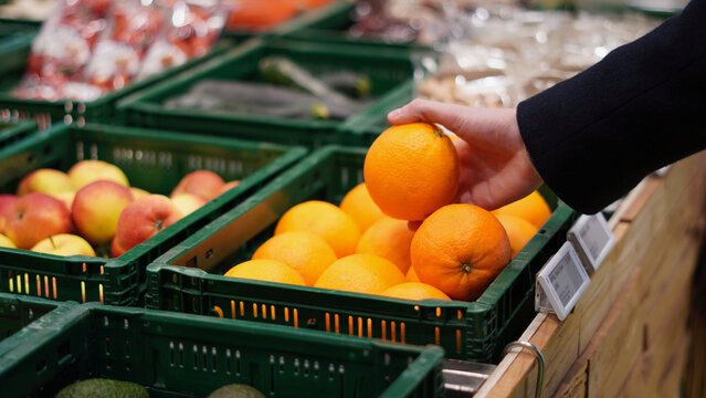 Person buying fruit, orange