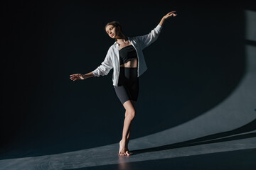 Beautiful young modern dancer or fitness dancer on a white isolated background