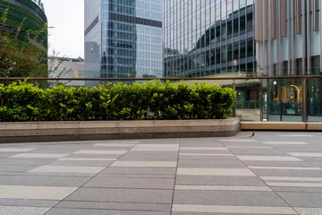 Foto op Plexiglas empty concrete floor in front of modern buildings in the downtown street. © helloabc