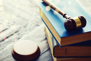 Wooden judge gavel and legal book on wooden table