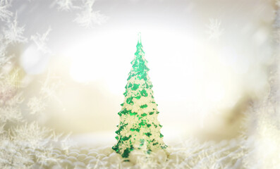 Fototapeta na wymiar Abstract Christmas background. Frozen postcard with decoration in the shape of a Christmas tree and balls.