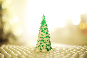 Christmas background. Dish in the shape of a Christmas tree with balls decorations on the table.