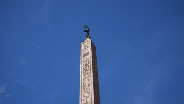Closeup of upper side of ancient Egyptian obelisk on Piazza Navona in Rome on sunny day on background of blue sky. Italian name Obelisco Agonale. Fountain of Four Rivers - Fontana dei Quattro Fiumi.