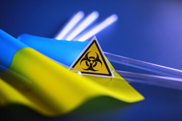 Ukrainian flag biohazard and test tubes. Assistance to Ukraine in biolaboratories. Western...
