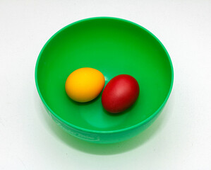 Coloured eggs in green bowl