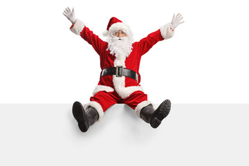 Full length portrait of an excited santa claus sitting on a blank panel