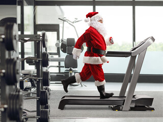Santa Claus running on a treadmill at a gym