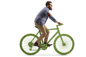 Naklejka premium Bearded man riding a bicycle made of grass