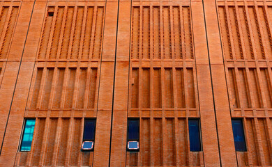 Orange brick wall of a high-rise building, exterior decoration style, building construction, classic style, looks solid.