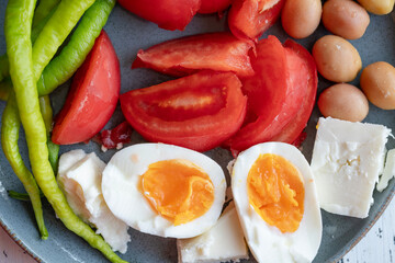 boiled eggs, cheese and salad on plate