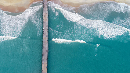 Aerial fishing pier with surfers in Outer Banks