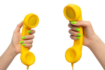 Yellow handset in woman hand with green nails isolated on a white background.