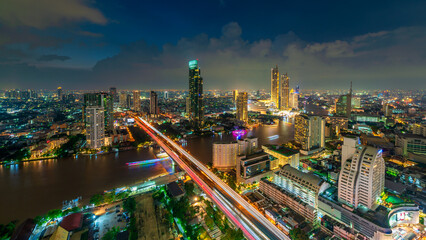 Evening view with business buildings along the river at Bangkok, Thailand