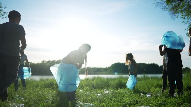 group of volunteers clean up the trash. environmental protection ecology cleaning from garbage plastic concept. group people volunteers collects plastic bottles garbage world in bags silhouette