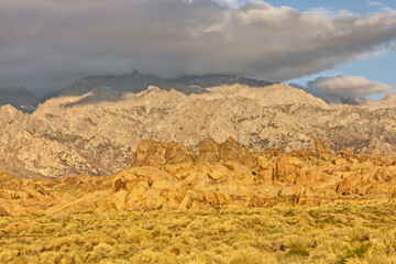 Fototapeta na wymiar Alabama Hills Landscape with Eastern Sierra Nevada Mountains in the Background During Morning Golden Hour