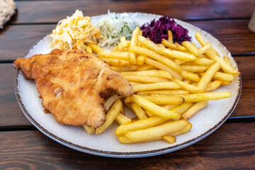 Traditional Polish Chop, Breaded Cutlet, Roasted Pork Steak in Breadcrumbs with Fresh Cabbage Salads