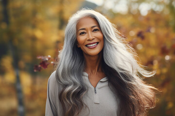 Fototapeta premium Generative AI technology picture of gorgeous grey haired woman walking autumn park