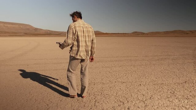 Exhausted man walking through the desert