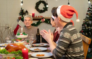 Happy asian family celebrating Christmas and New Year together at home.