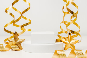 Empty white podium with golden shining ribbon on white background. Holiday showcase for product...