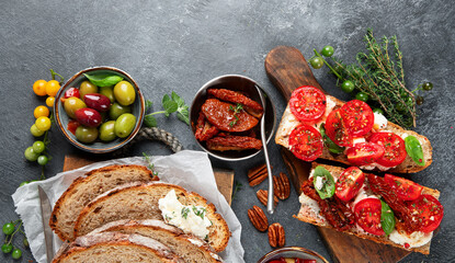 Italian antipasti snacks set. Tasty bruschettas with cheese, sun-dried tomatoes. Traditional food concept