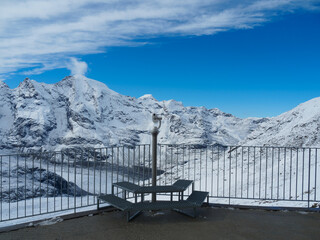 Long shot of modern telescope at Diavolezza view point, for seeing closely the Bernina Range, one of famous travel destinations in Switzerland. Clearly see Piz Morteratsch and Piz Prievlus on the left